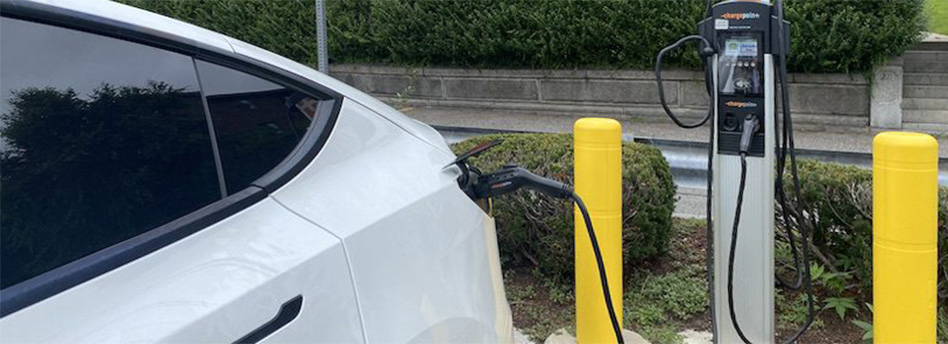 photo of white car connected to an EV Charger